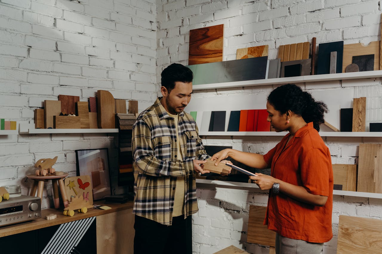 A man and woman discussing samples in a contemporary showroom setting.